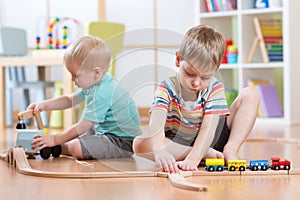 Children playing with educational toys and building rail road