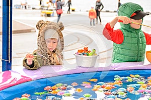 Children Playing at Fishing Pond Game at Fun Fair