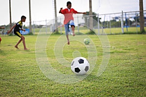 Children playing football on the field