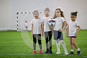 Children playing football indoors. Girls football team