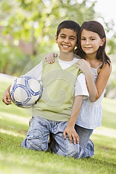 Children playing football in park