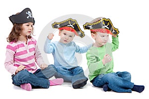 Children playing game in kids party pirate hats