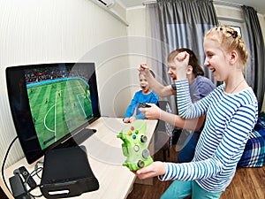 Children playing on games console to play football