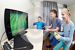 Children playing on games console to play football