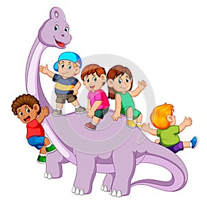 The children playing and get into the saurolophus body and some od them holding his neck it photo