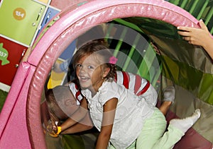 Children playing and having a good time in kids zone in amusemen