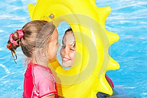 Children playing inflatable ring.