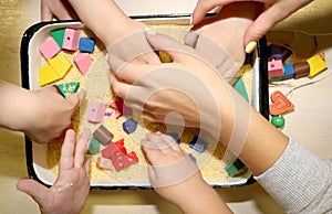 Children playing with kinetic sand, croup and designer in preschool. The development of fine motor concept. Creativity Game