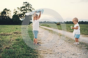 Children playing with kite on nature in countryside