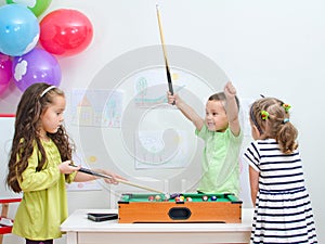 Children playing mini billiard