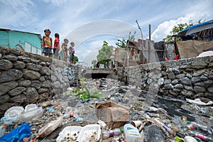 Children Playing Near The Aqueduct Full Of Garbage And Waste By The Ozama River