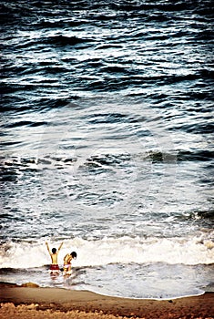 Children Playing in the Ocean