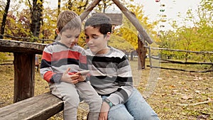 Children playing in online games. Kids playing with electrical gadgets