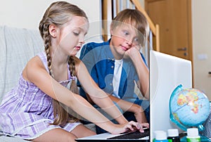 Children playing online on laptop