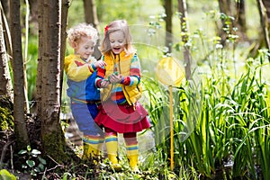 Children playing outdoors catching frog