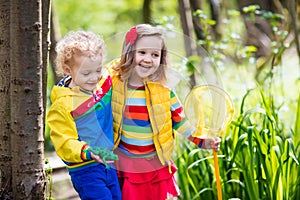 Children playing outdoors catching frog