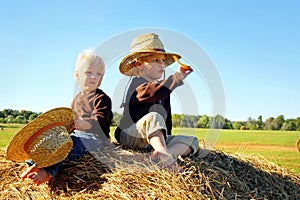 Children Playing Outside on Hay Bale