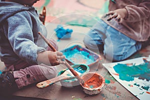 Children playing with paints and tempera