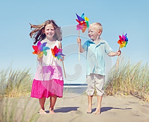 Children Playing Pinwheels by the Coastline