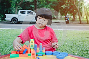 Children playing with plastic bricks on a marble table Educational toys for school-age and kindergarten children
