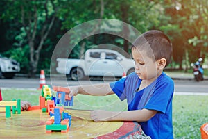 Children playing with plastic bricks on a marble table Educational toys for school-age and kindergarten children