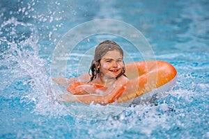 Children playing in pool. Happy young child enjoying summer vacation outdoors in water in the swimming pool. Cute little