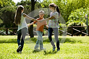 Children playing ring-around-the-rosy photo