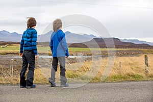 Children, playing on a road near non active vulcano in Snaefellsjokull National Park