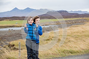 Children, playing on a road near non active vulcano in Snaefellsjokull National Park