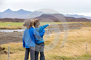 Children, playing on a road near non active vulcano in Snaefellsjokull National Park