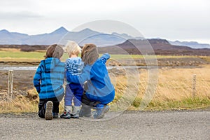 Children, playing on a road near non active vulcano in Snaefellsjokull National Park