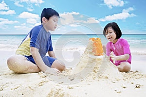 Children playing sand at coast