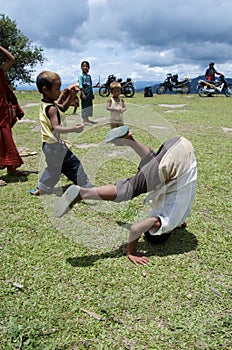 Children playing on the school field working on the headstands