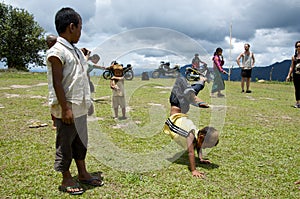 Children playing on the school field working on the headstands