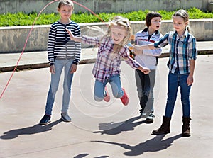 Children playing skipping rope jumping game