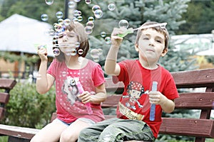 Children playing with soap balloons