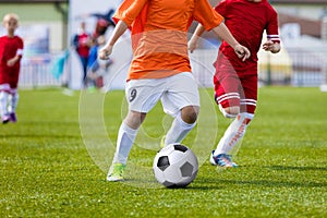 Children playing soccer football match. Running players and kick