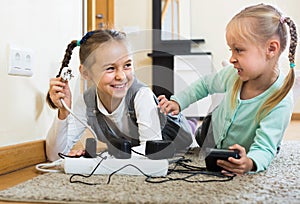 Children playing with sockets and electricity indoors