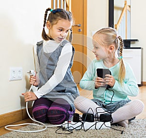 Children playing with sockets and electricity indoors