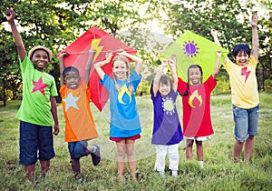 Children Playing Superhero With Kites photo