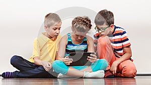 Children playing on tablet.