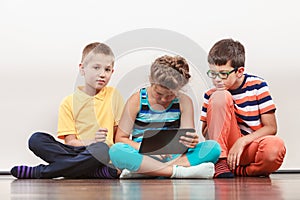 Children playing on tablet.