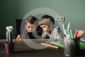 Children playing tablet at home, growing up with technology