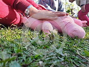 Children playing with teddy bear in a park. Body parts of Kids seems playing with toys. Children often express emotions and