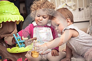 Children playing together in kids rooms with toys symbolizing children communication and happy childhood