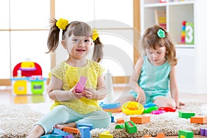 Children playing together. Toddler kids play with blocks. Educational toys for preschool and kindergarten child. Little