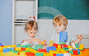 Children playing with toy train. Toddler kids play with blocks. Educational toys for preschool and kindergarten child.