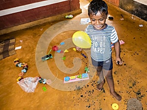 Children playing with toys balloon on the floor of the children's room. Kindergarten educational games in India