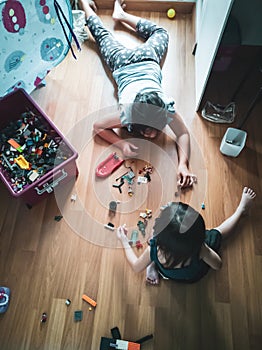 Children playing toys on the floors. Top view