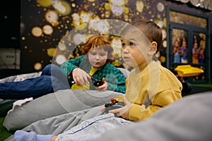 Children playing video game in entertainment center